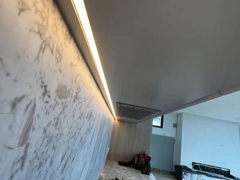 LED strip lighting under a kitchen bulkhead above a marble splashback