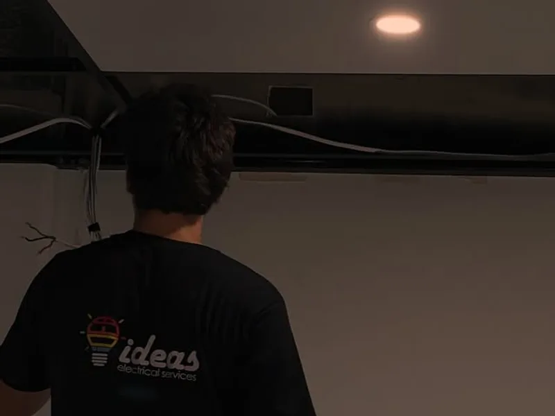 Ideas Electrical Services electrician on site checking a new downlight